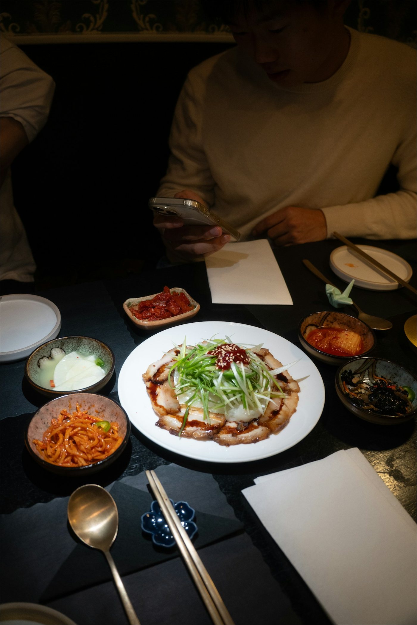 Friends sharing a Korean meal with banchan